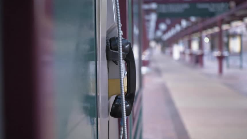A public pay phone on the wall of a train station