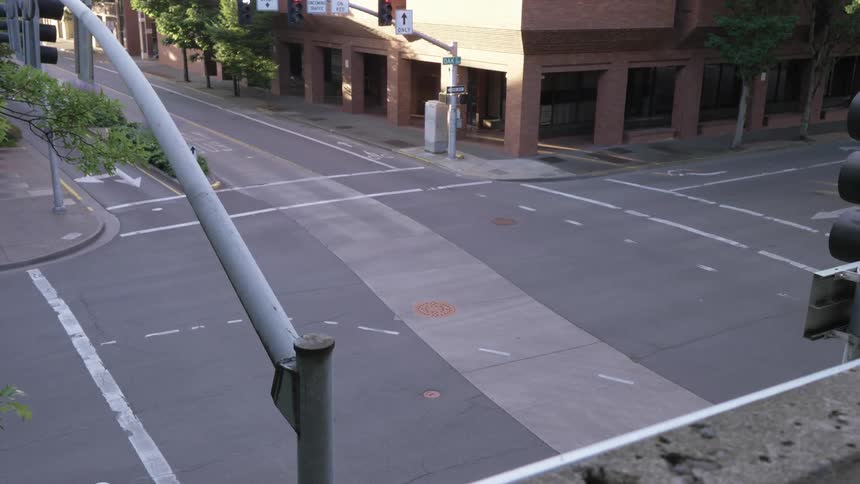 Crosswalk at intersection with buildings on the side of the road