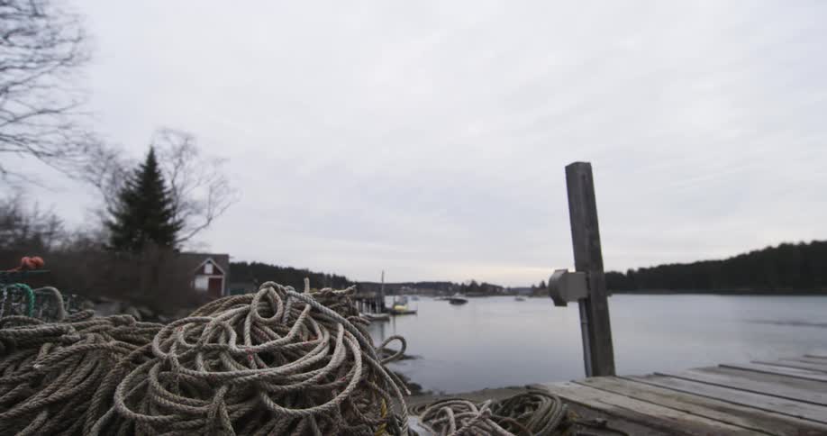 Ropes piled up on a pier on an overcast day