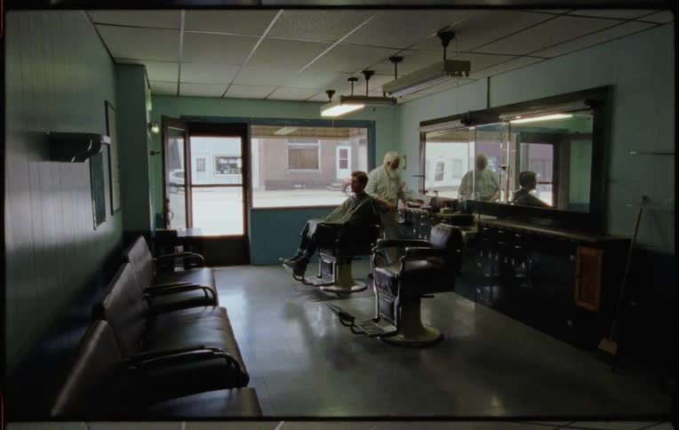 A man is getting a haircut in a salon
