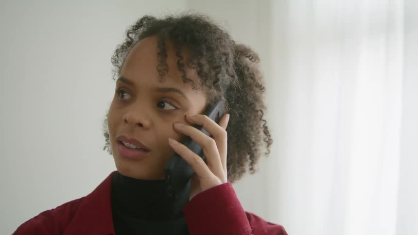 A woman is listening on her cell phone