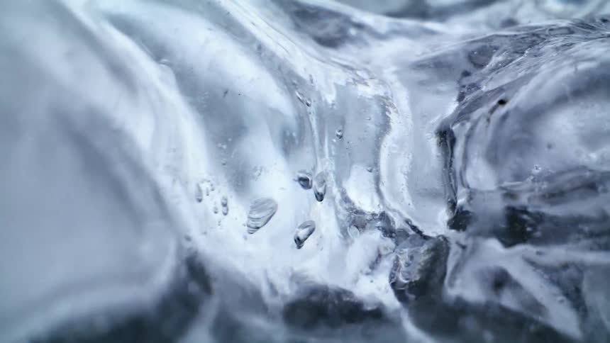 A clear liquid moving around in a clear piece of ice