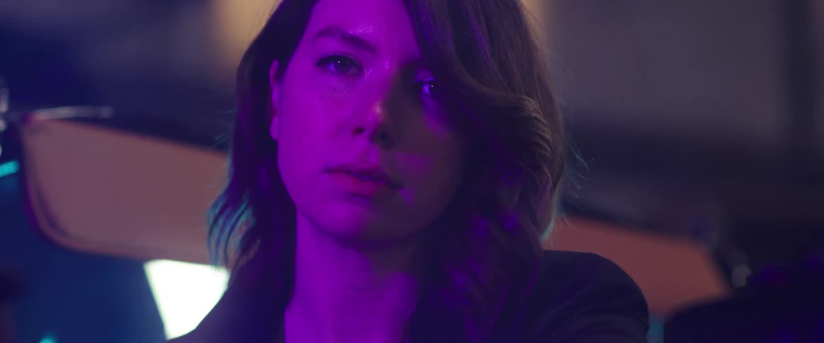 A woman is standing in a room next to a window