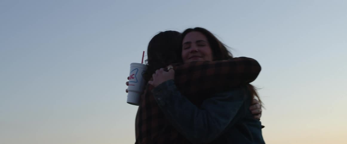 Two women hugging each other