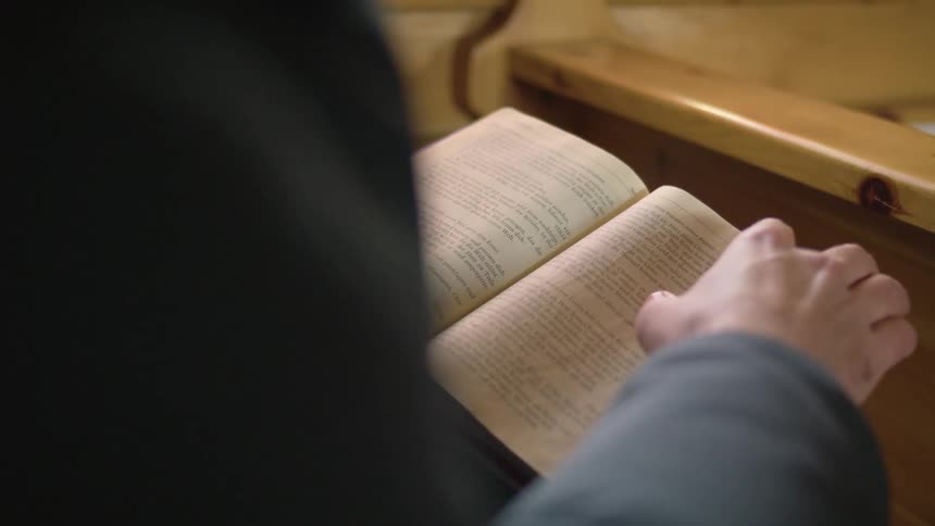 A person in a church reading a bible