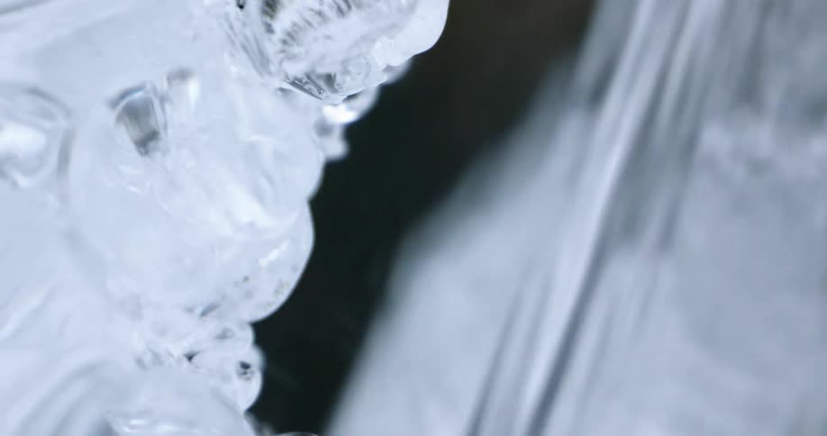 A close up view of water running over some ice