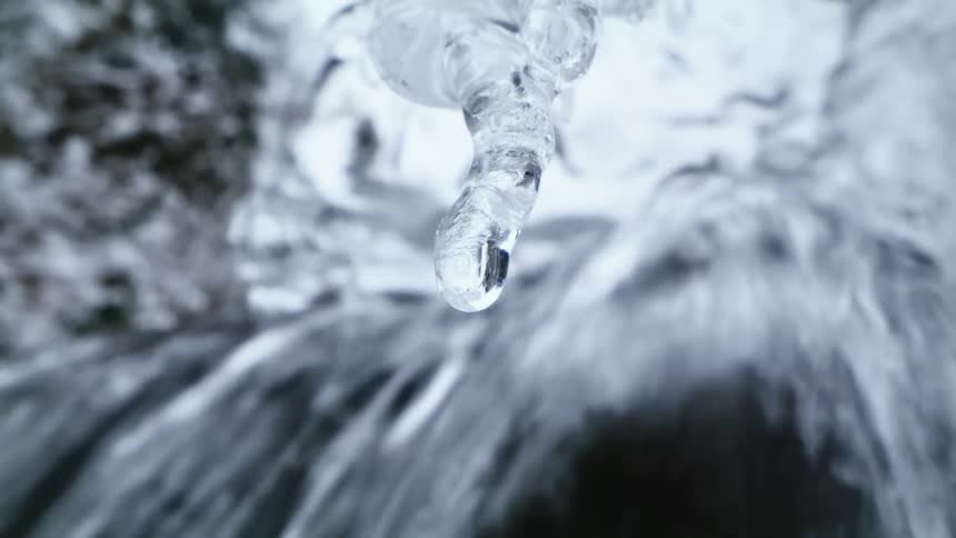 A waterfall with ice and snow melting