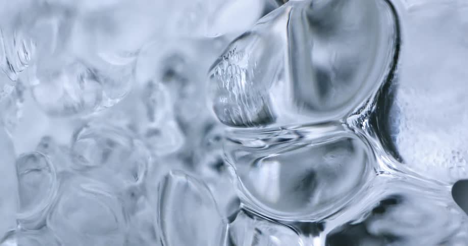 Close up of water running under ice