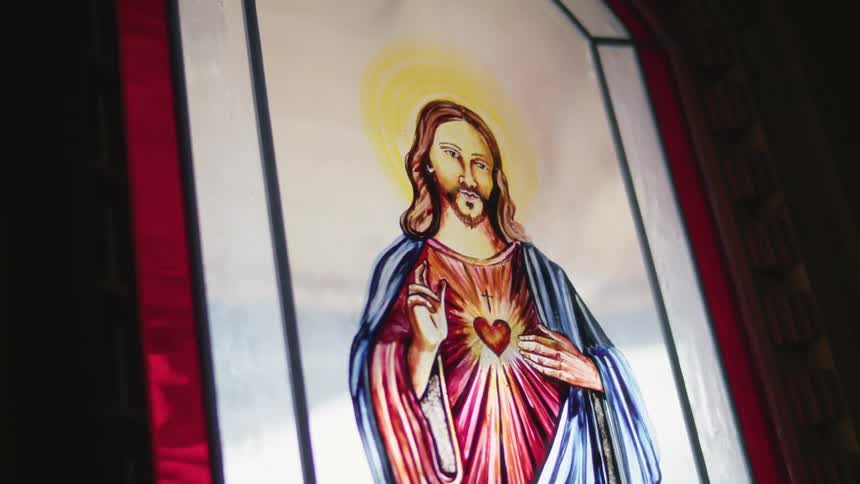 Picture of the sacred hearth of jesus on a stained glass window in a church