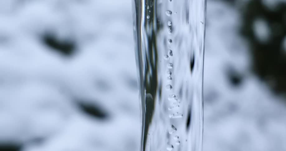 An icicle shines and reflects the surroundings