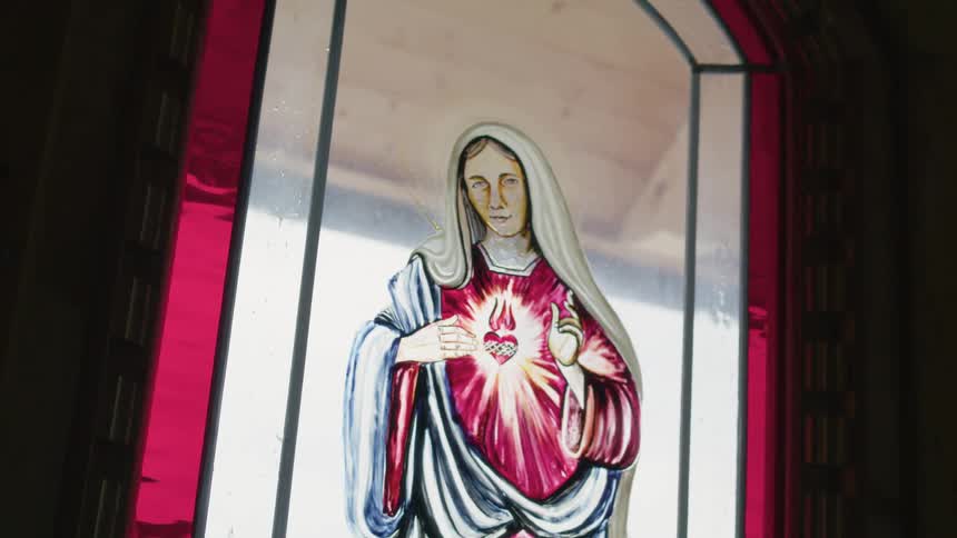 The sunlight is coming in the stained glass window