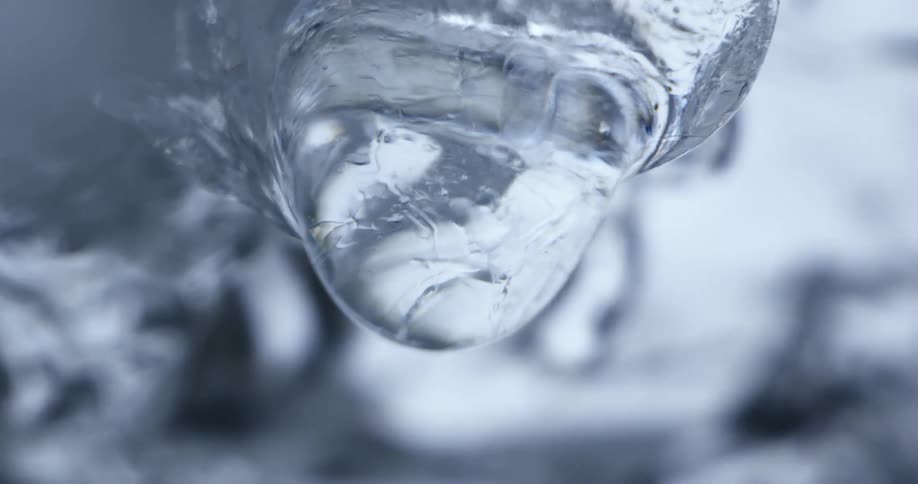 Water falling off of ice at a river