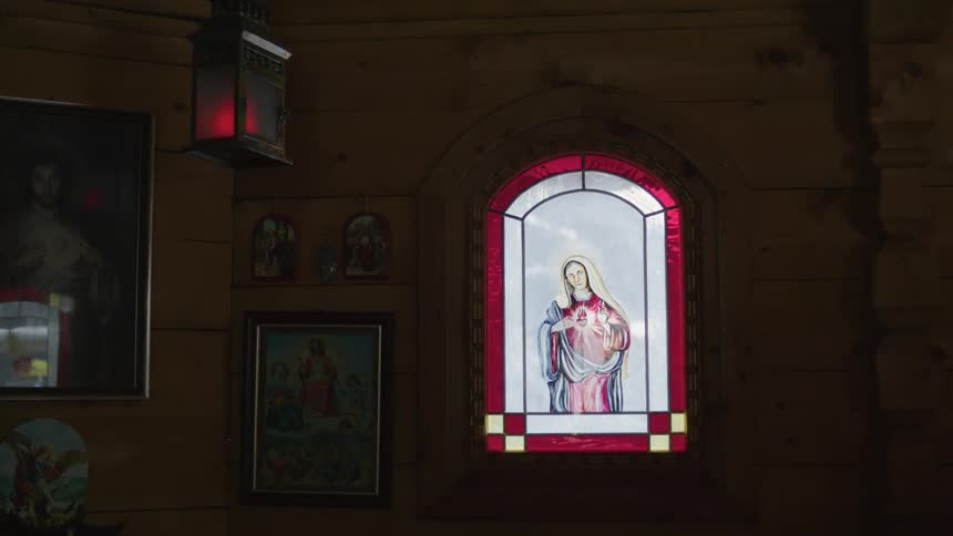 The light is coming in through the stained glass window