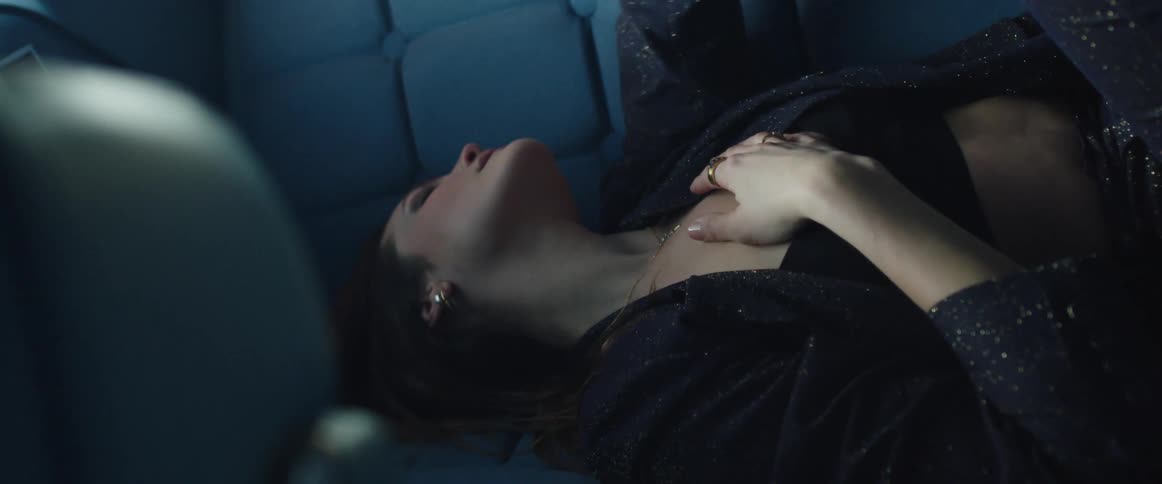 A woman laying in the backseat of a vehicle