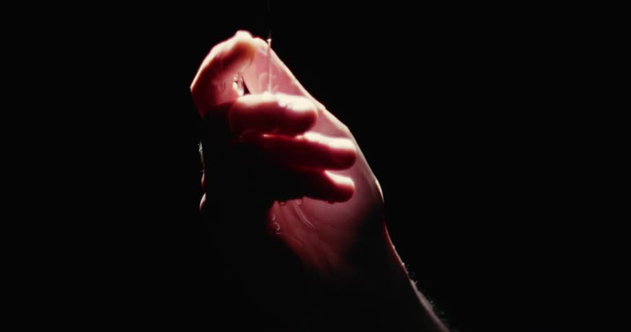 A person dripping wax onto their hand