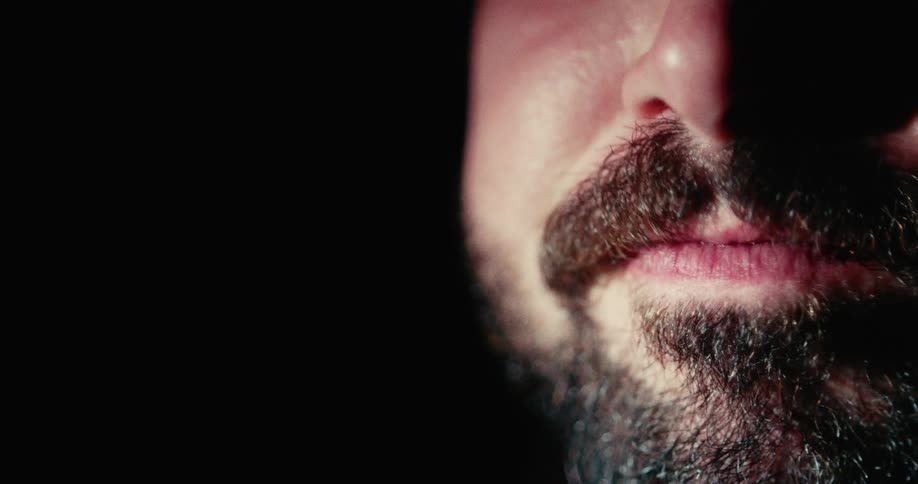 Close up of a mans lips staining red while drinking wine from a glass