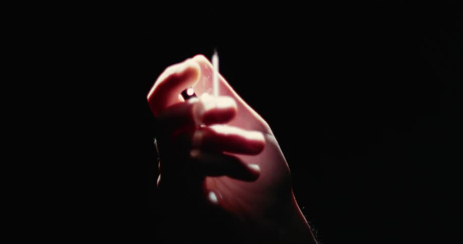 A person holds a tube of viscous liquid and slowly drips it onto their other hand below