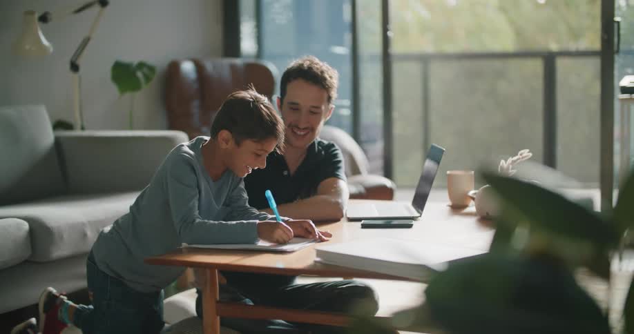 A father and son doing homework together