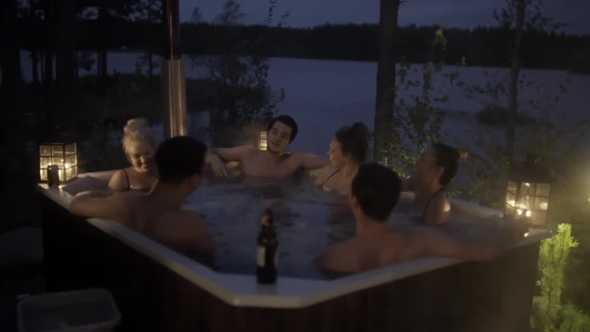 A group of people are talking in a hot tub