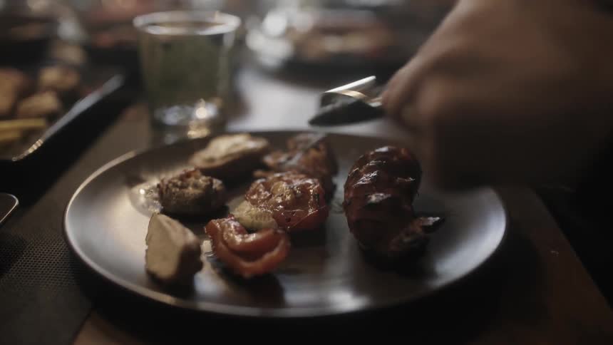 A man is preparing his food on a plate