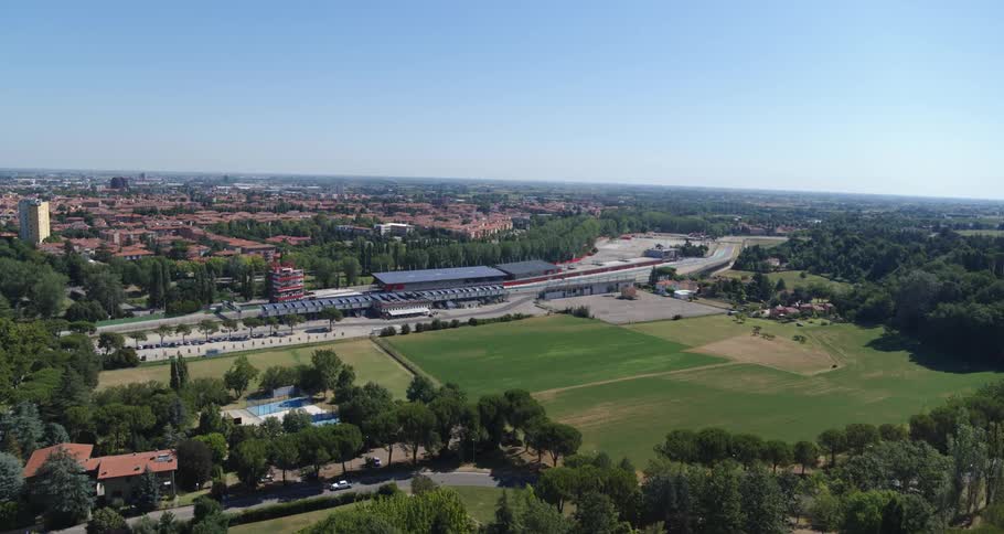A field sits before the town on a sunny day