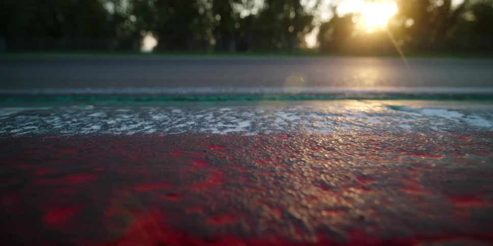 The sun shines through the trees onto a colorful painted road side