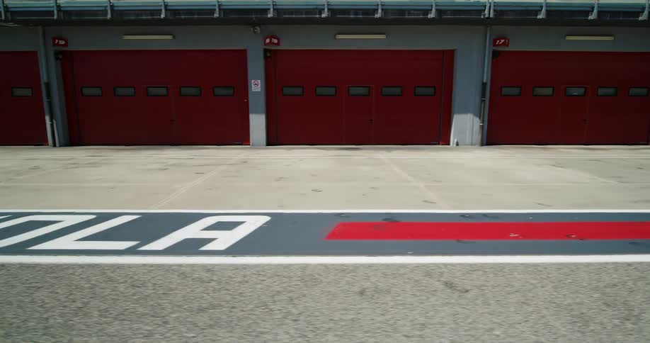 The building is covered with red garage doors