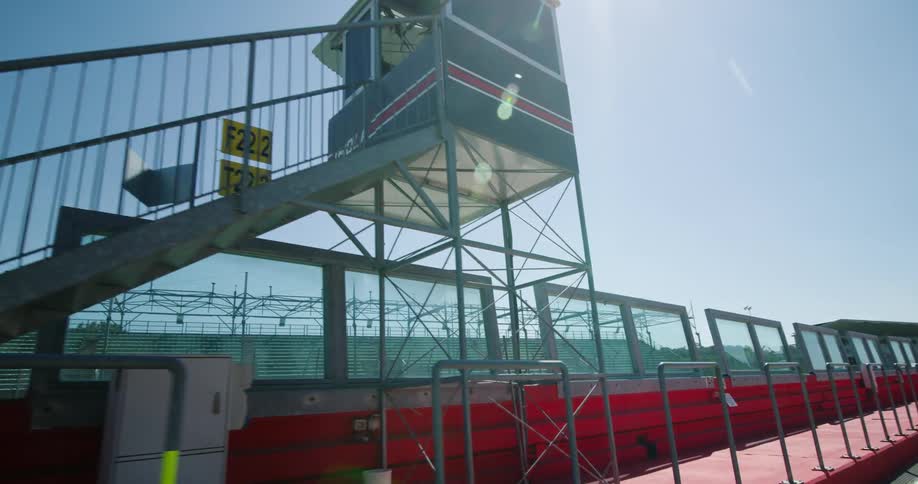 Asphalt on a race track and the buildings and stands at the track