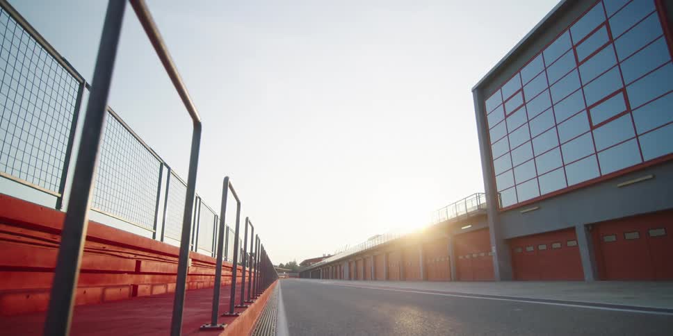 The road runs past the row of storage units
