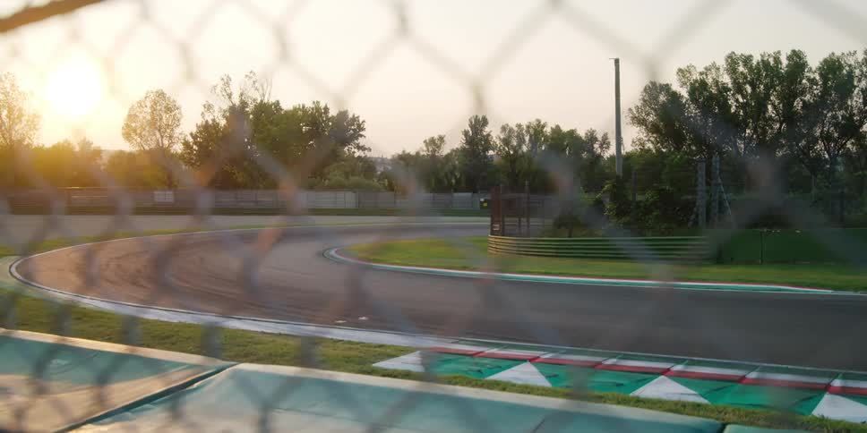 Trees grow in the middle of a fenced in race track