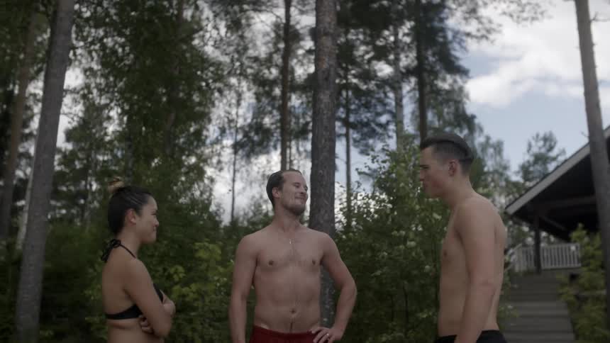 People in bathing suits standing together while talking