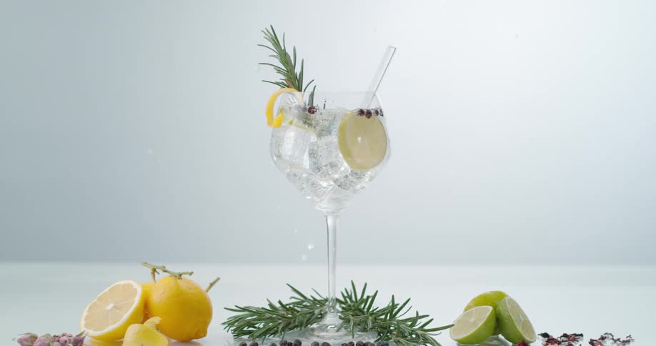 A piece of ice is dropped into the drink