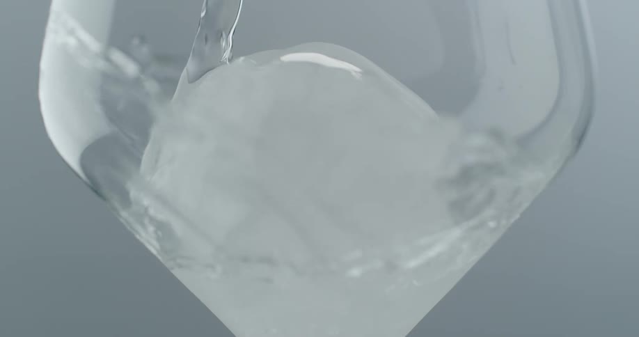 Water being poured over ice in a glass