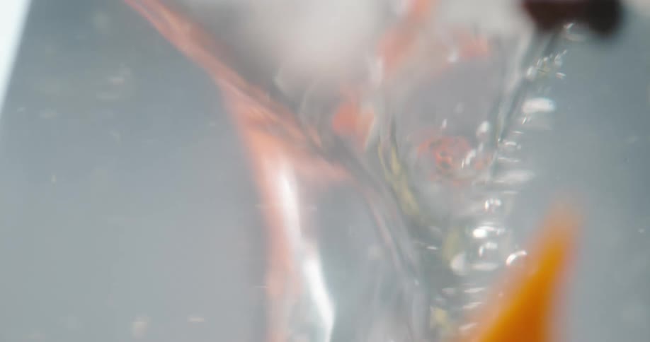 A slice of fruit is dropped in the drink
