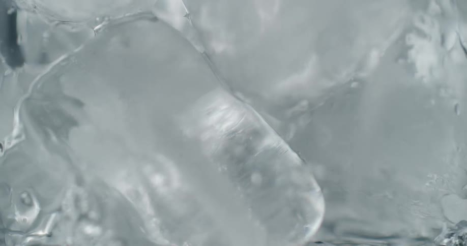 Ice and a clear liquid moving in a container