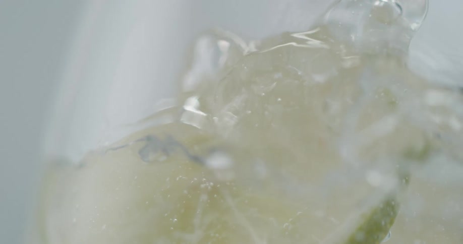 A lime drops in to a drink