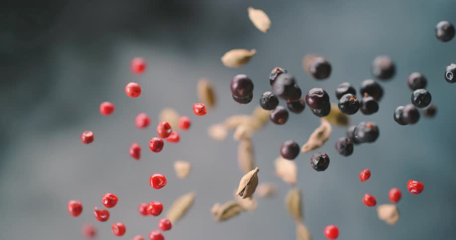 Berries and nuts falling in the air in a studio