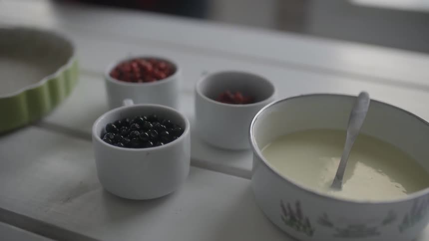 Berries and baking ingredients sit on a kitchen table