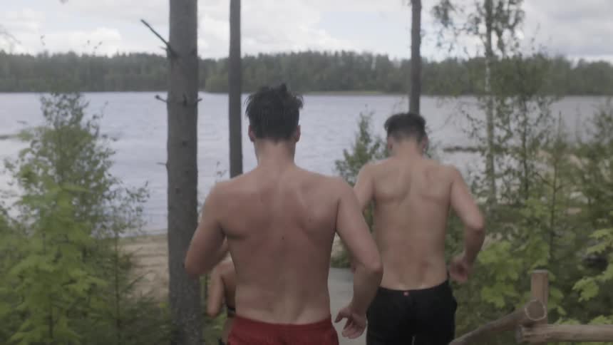 People jogging down stairs to a lake beach