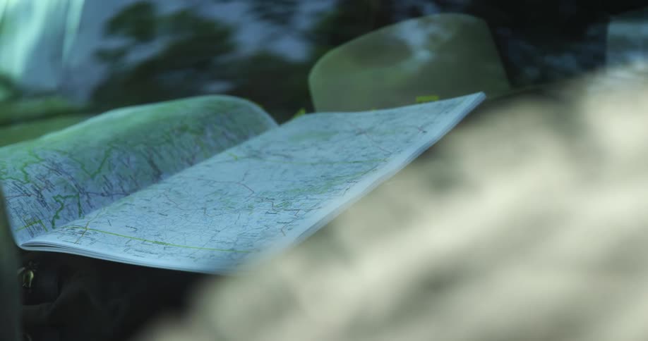 An opened map sits in a packed vehicle
