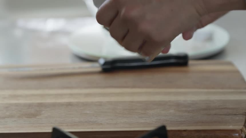 A person unwrapping a pack of butter