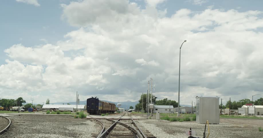 A train parked next to a train track in a small town