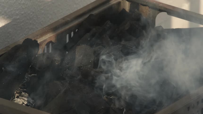 Smoke rising from burning pieces of wood
