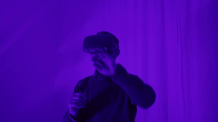 A man wearing a vr headset is using his hands to scroll through a menu or play a game