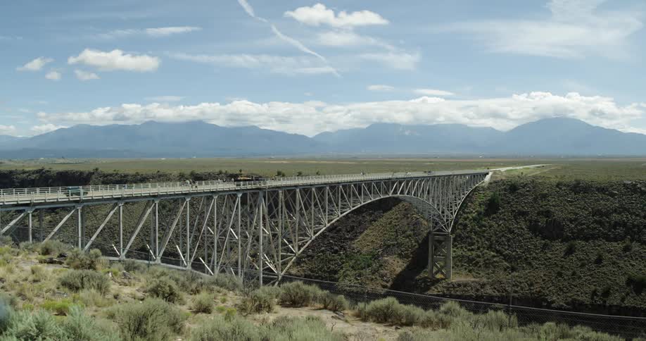 Cars drive over a bridge during the day