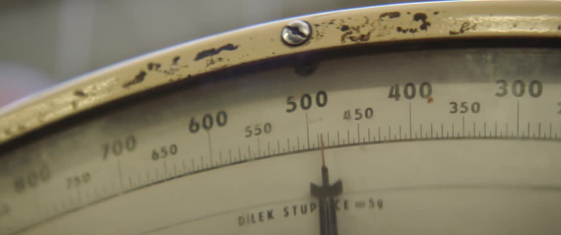 A view of a needle on a scale moving and stopping