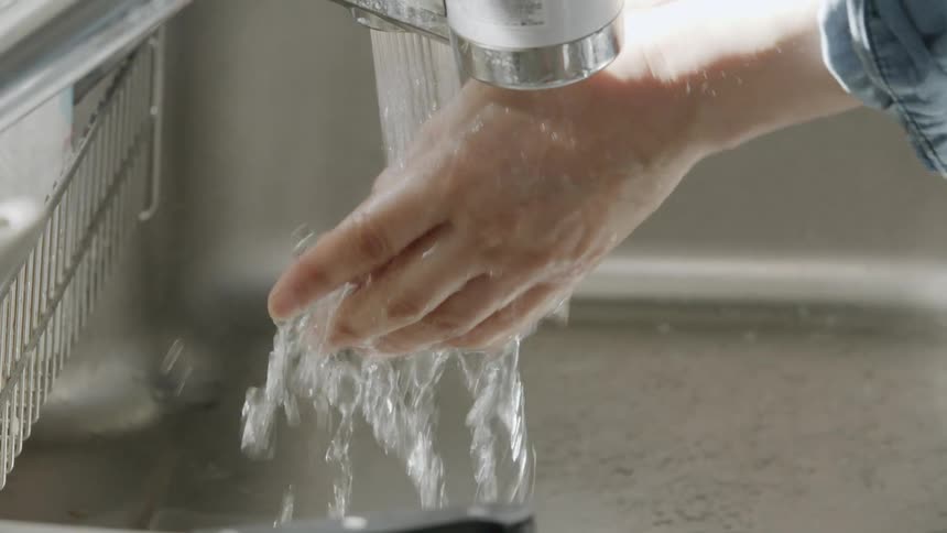 A person is washing their hands in the sink