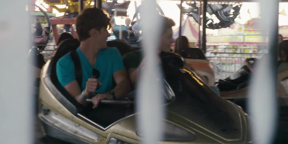 Youth in bumper car with friend steers car