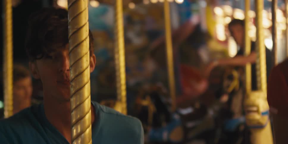 A man and a woman sitting in a carousel