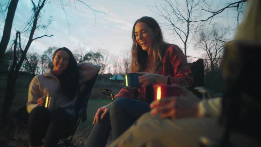 People sitting around camping and talking
